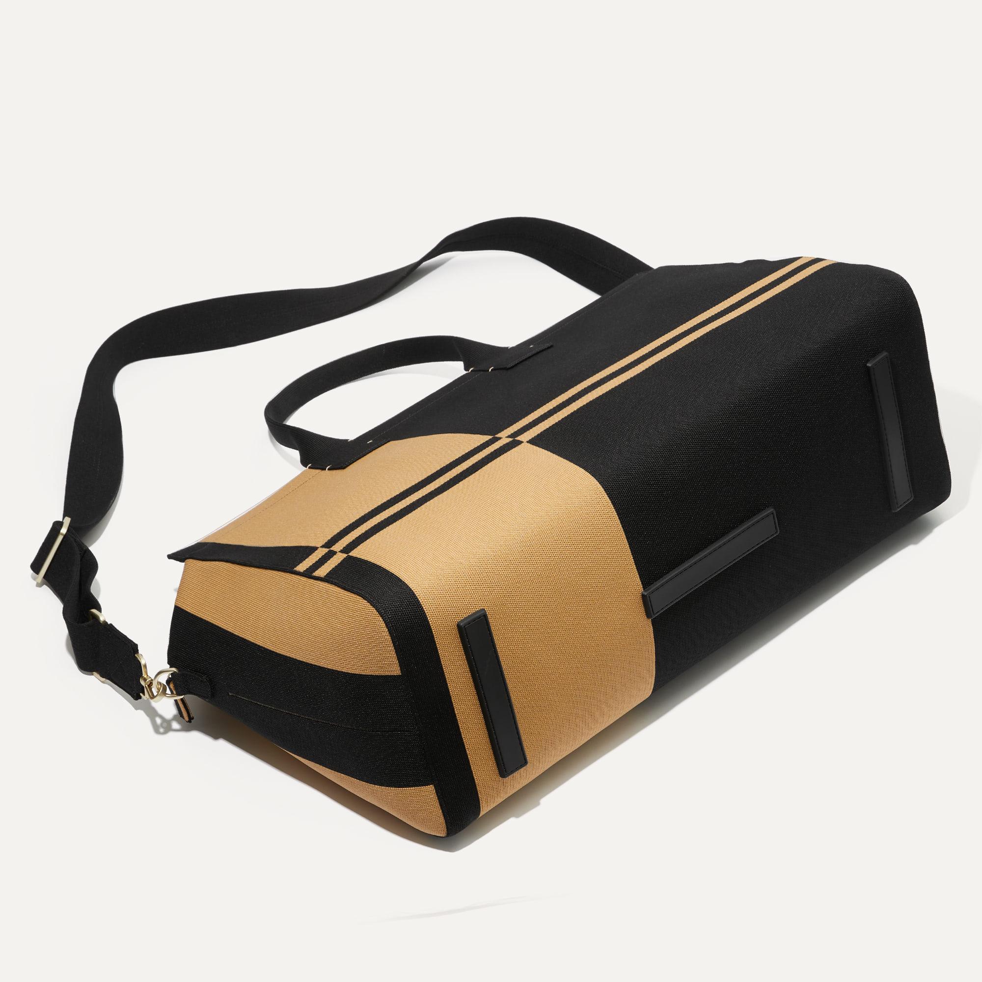 The Weekender in Camel and Black shown laid down.