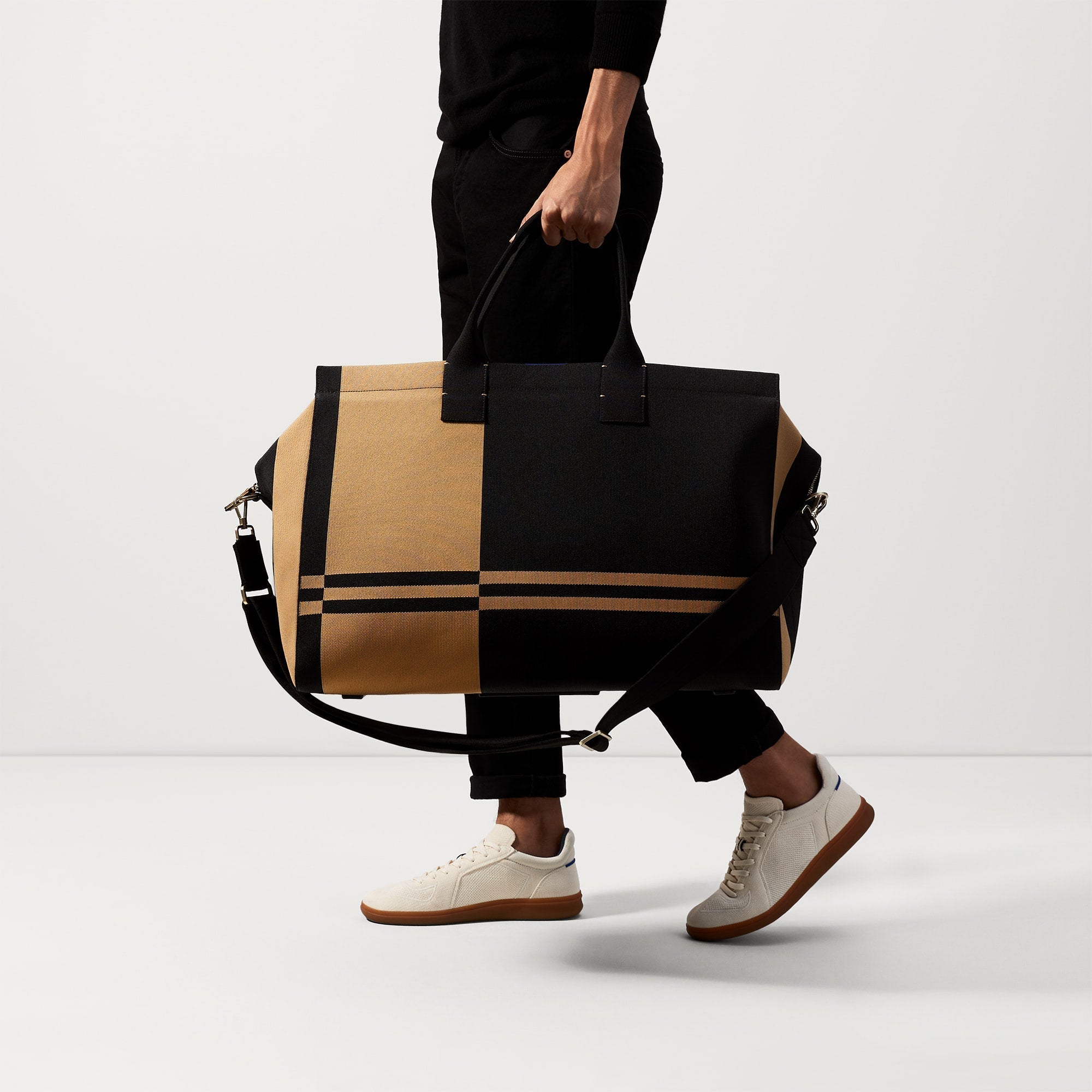 An alternate view of The Weekender in Camel and Black on a model.