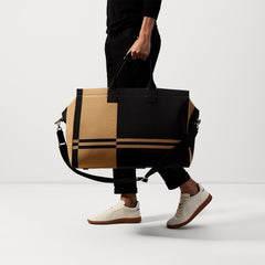 An alternate view of The Weekender in Camel and Black on a model.