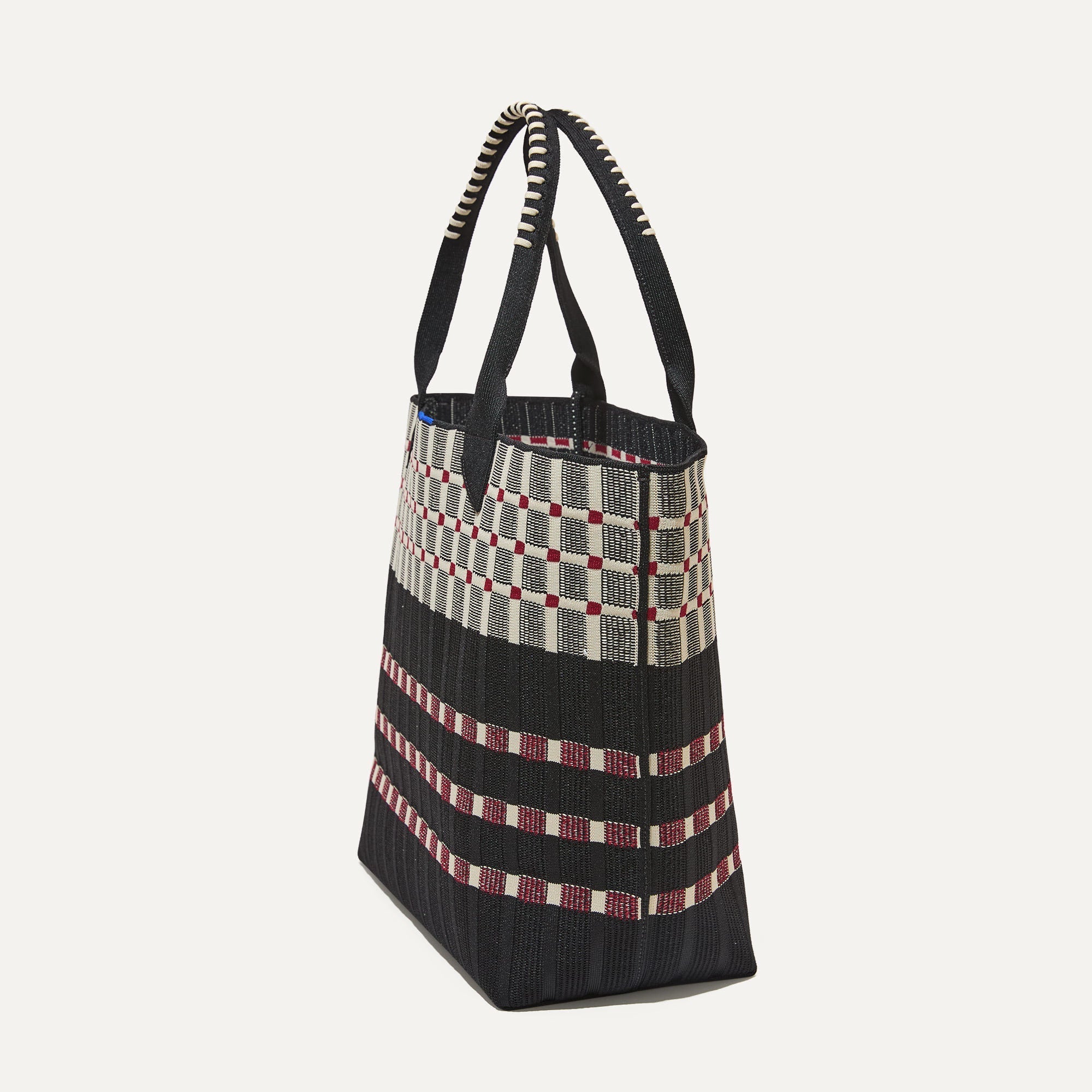 The Lightweight Tote in Checker Classic shown in Newspaper.