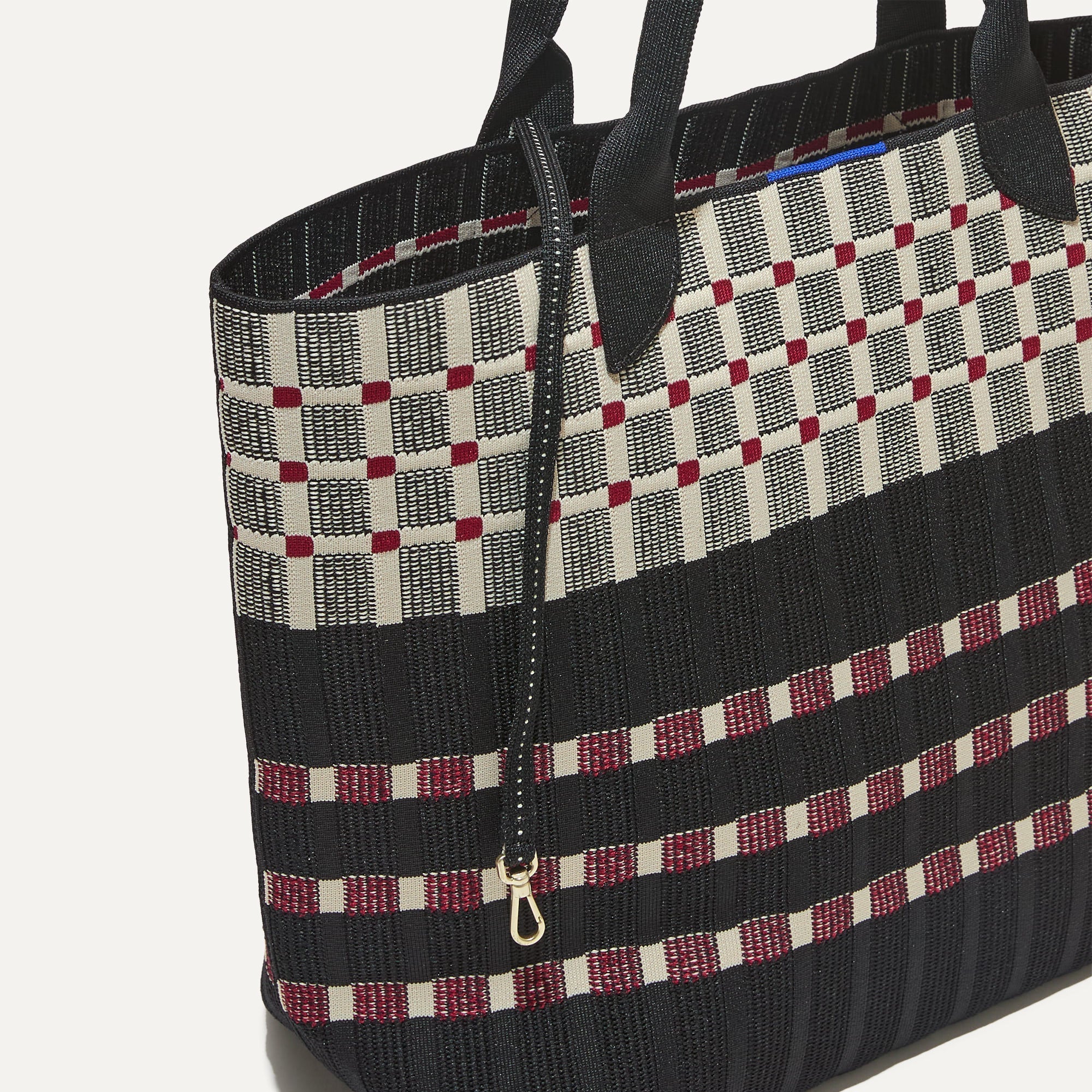 The Lightweight Tote in Newspaper shown with its handy key leash.