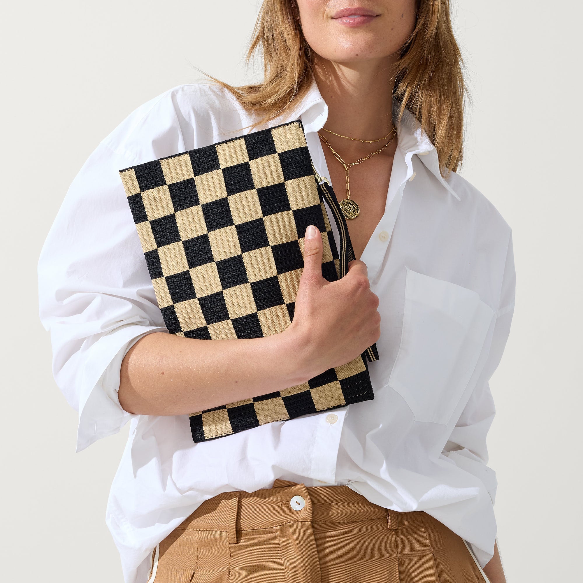 hover | Model holding The Wristlet in Checker Classic.