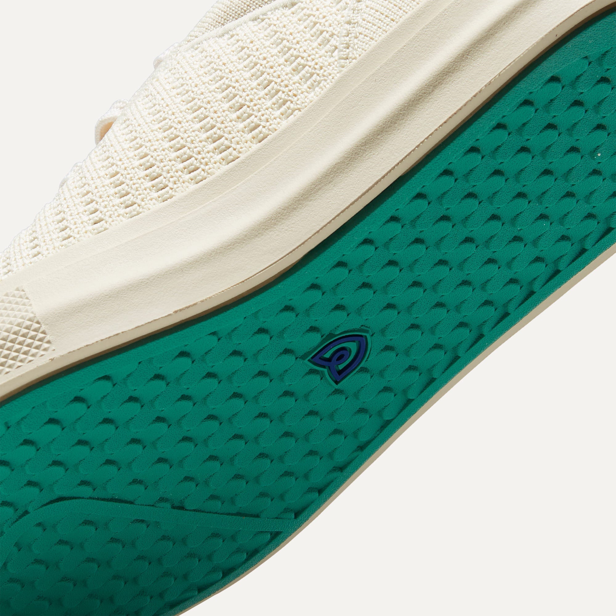 Close up of the outsoles of The RS02 Sneaker in Courtside White, with raised grooves for added traction.