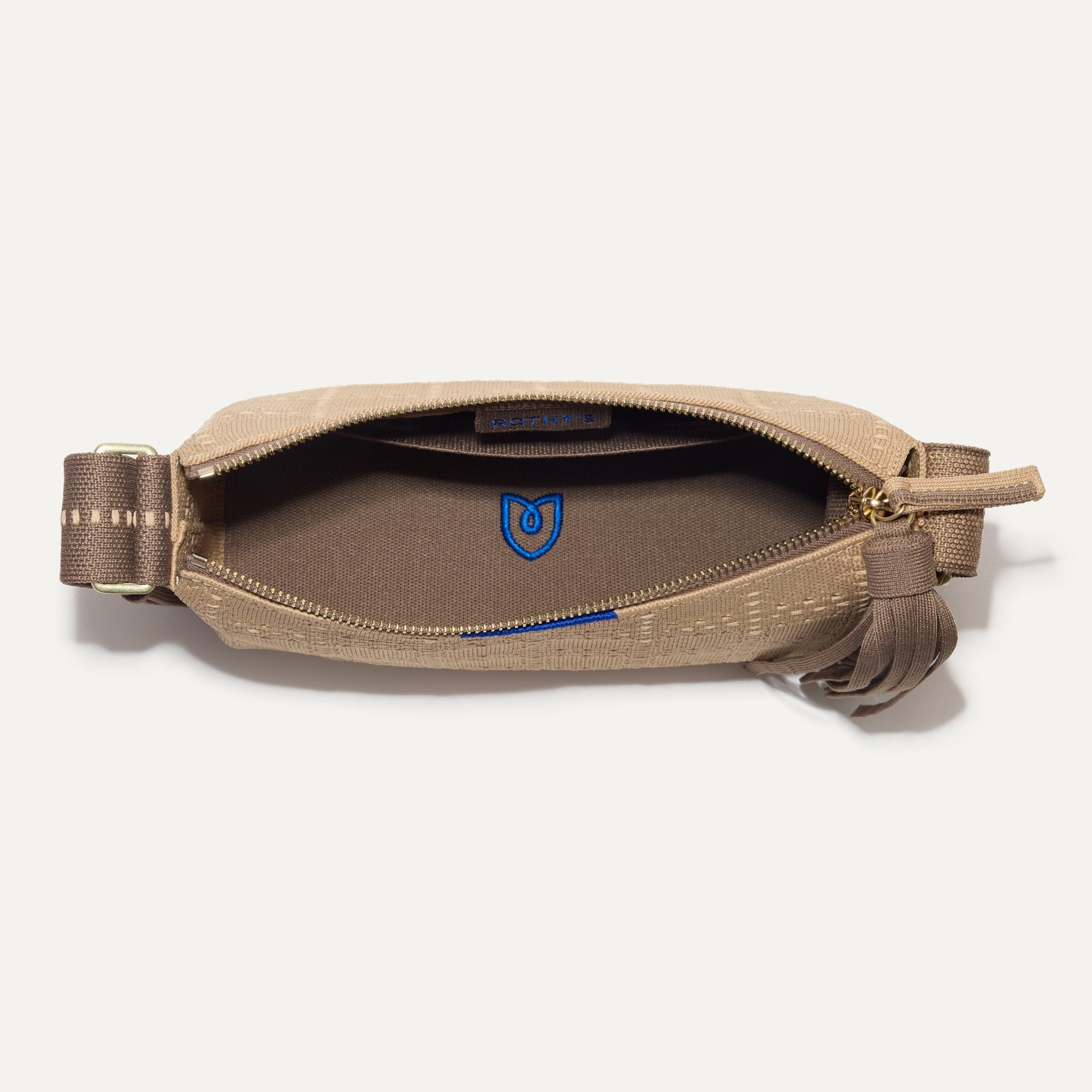 The Casual Crossbody in Brown Perf, shown from above, with the interior exposed. 