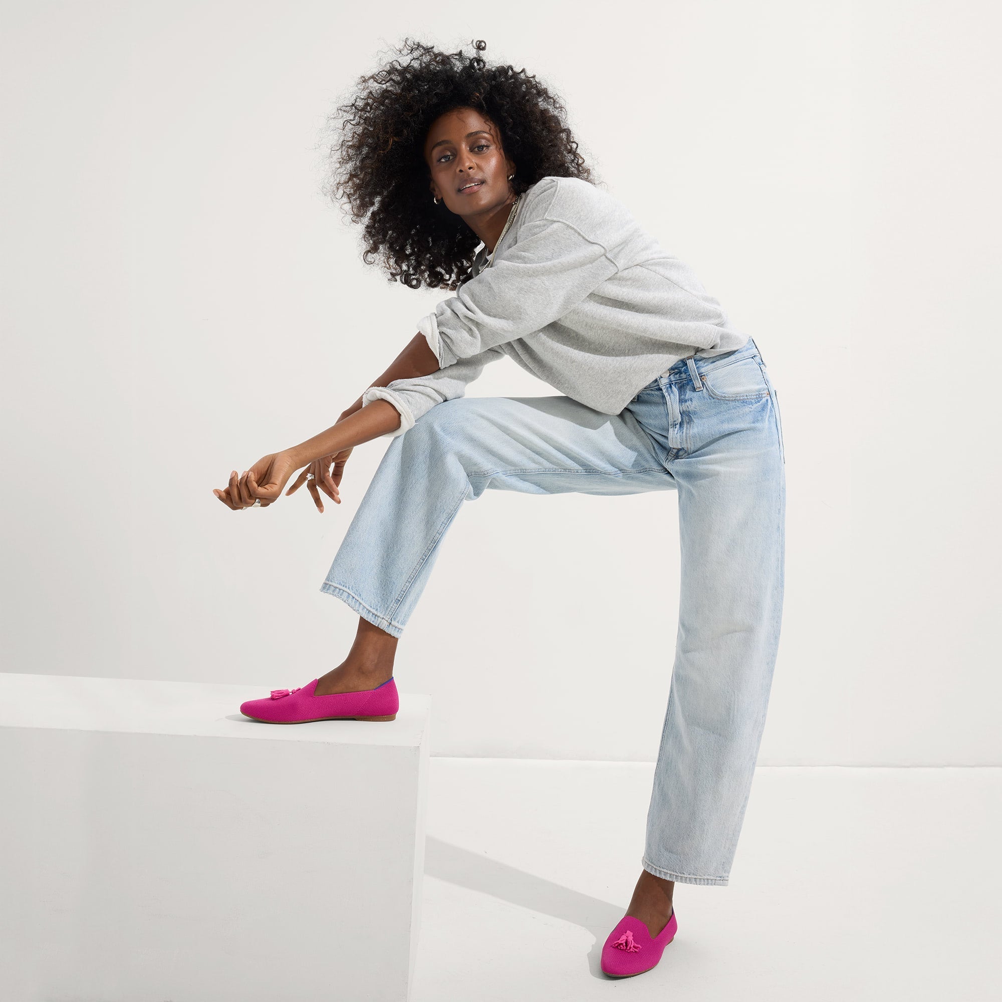 Alternate view of a model wearing The Almond Tassel Loafer in Pink Bramble.