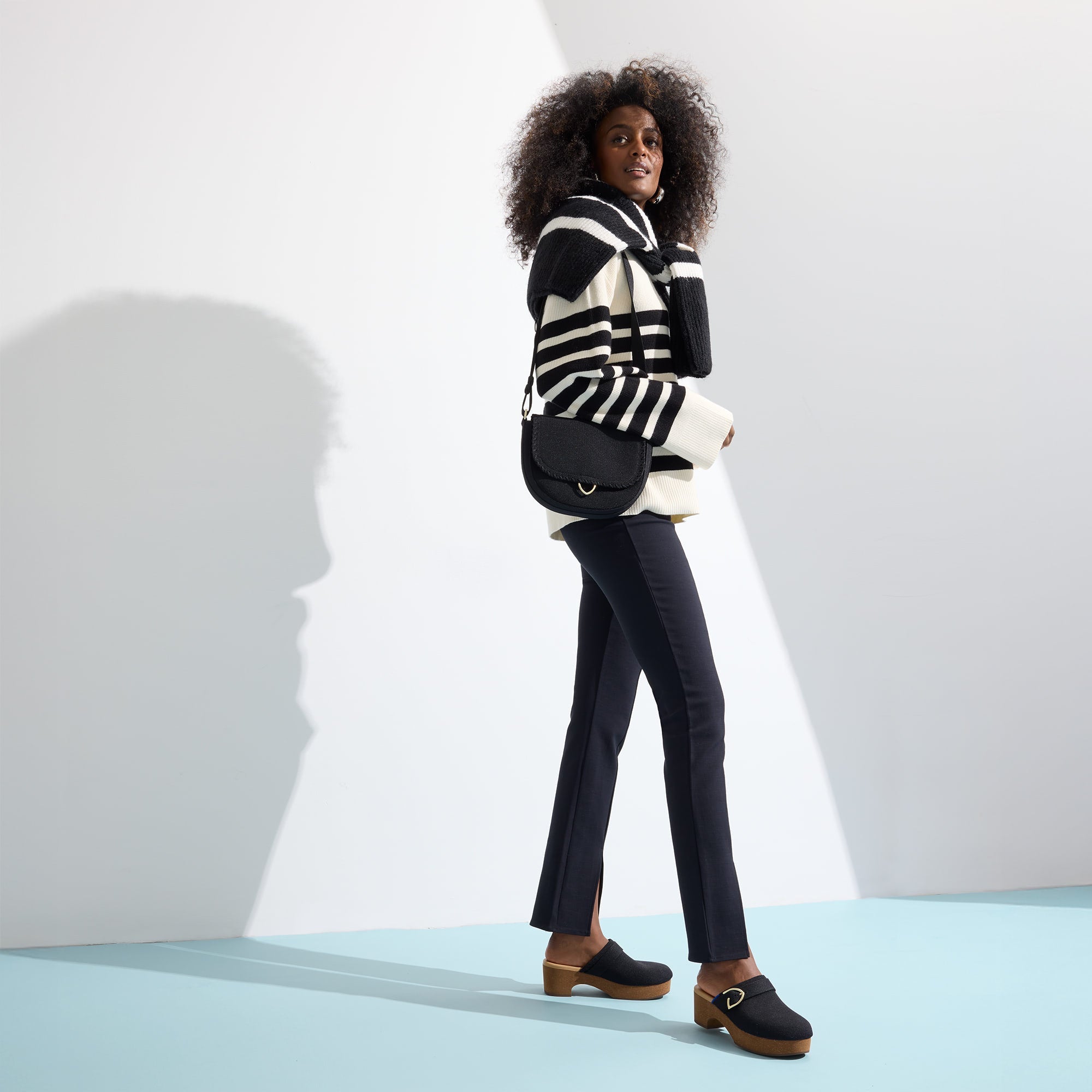 Alternate view of a model wearing The Classic Clog in Black.