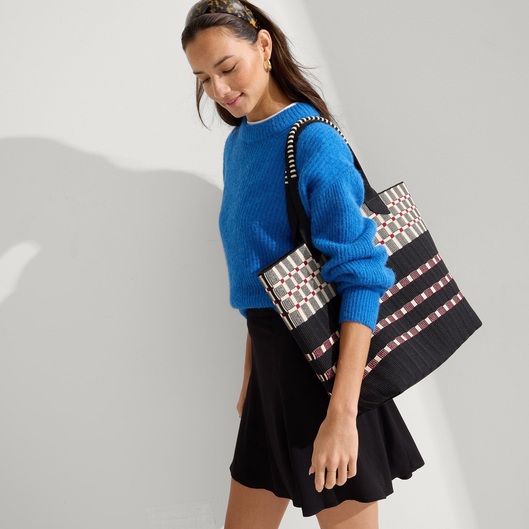 hover | Model holding The Lightweight Tote in Newspaper.